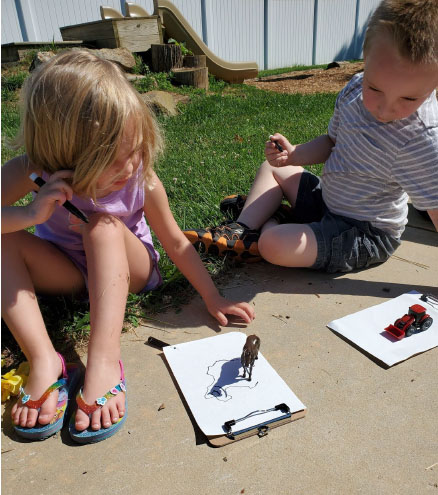 kids investigating while in an outdoor classroom